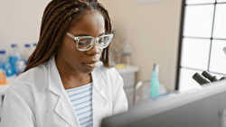 Concentrated african american woman with braids working in a science laboratory indoors; Shutterstock ID 2492753973; purchase_order: Bynder library; job: ; client: ; other: 