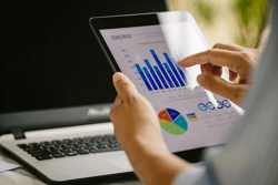 Digital marketing, businessman using smart tablet and documents on office desk background. Concept for business strategy, economy and tax.